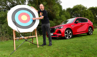 Auto Express chief sub-editor Andy Pringle standing next to an archery target